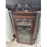 A 19TH CENTURY ASTRAGAL GLAZED CORNER CUPBOARD WITH BROKEN SWAN NECK PEDIMENT AND SHAPED INTERIOR