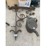 A VINTAGE WROUGHT IRON HANGING BASKET BRACKET AND A BRASS KETTLE