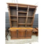 A VICTORIAN OAK BOOKCASE ON BASE WITH OPEN SHELVES TO THE UPPER PORTION AND THREE CUPBOARDS TO THE