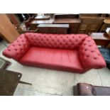 A RED CHESTERFIELD FOUR SEATER SETTEE