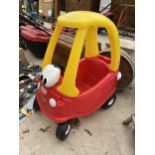 A RED AND YELLOW LITTLE TIKES COZY COUPE CAR