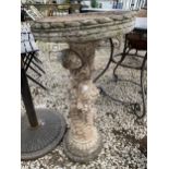 A RECONSTITUTED STONE BIRD BATH WITH CHERUB PEDESTAL BASE