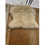 A SMALL SHEEP SKIN RUG