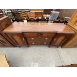 A VICTORIAN MAHOGANY BREAKFRONT SIDEBOARD ENCLOSING THREE DRAWERS AND TWO CUPBOARDS, 71" WIDE