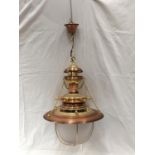 AN UNUSUAL BRASS AND COPPER PENDANT LIGHT WITH DOMED GLASS SHADE, SHIPS WHEEL DESIGN AND CHAINS
