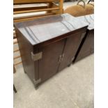 A MILLING ROAD (BAKER FURNISHINGS) TWO DOOR CABINET ENCLOSING FOUR INTERNAL DRAWERS, 36" WIDE