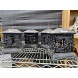 FOUR VINTAGE CAST IRON TEALIGHT HOLDERS