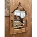 A WOODEN FRAMED WALL MIRROR WITH DECORATIVE CHAIN DETAIL