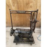 A VINTAGE SINGER SEWING MACHINE WITH CAST SINGER TREADLE BASE