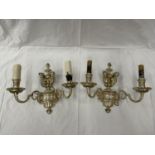 A PAIR OF WHITE METAL DOUBLE WALL LIGHTS WITH CHERUB STYLE DESIGN