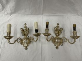 A PAIR OF WHITE METAL DOUBLE WALL LIGHTS WITH CHERUB STYLE DESIGN