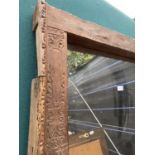 A LARGE INDIAN HARDWOOD FRAMED MIRROR, 64X37" AND A MODERN MIRROR, 44X36"