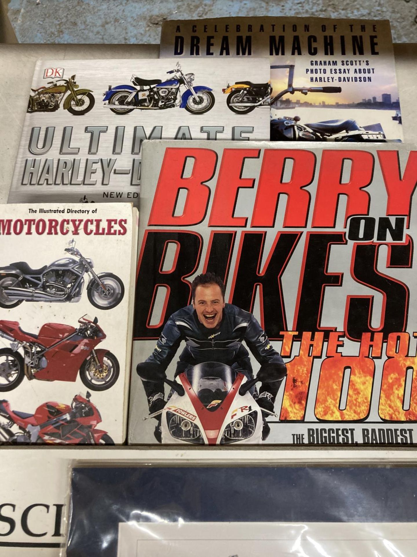 FOUR MOTOR CYCLING BOOKS, A CLASSIC HONDA WALL HANGING AND A CHILDREN'S PLAY AREA SIGN