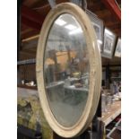 A CREAM FRAMED VINTAGE OVAL MIRROR WITH BEVELLED GLASS 75CM X 48CM