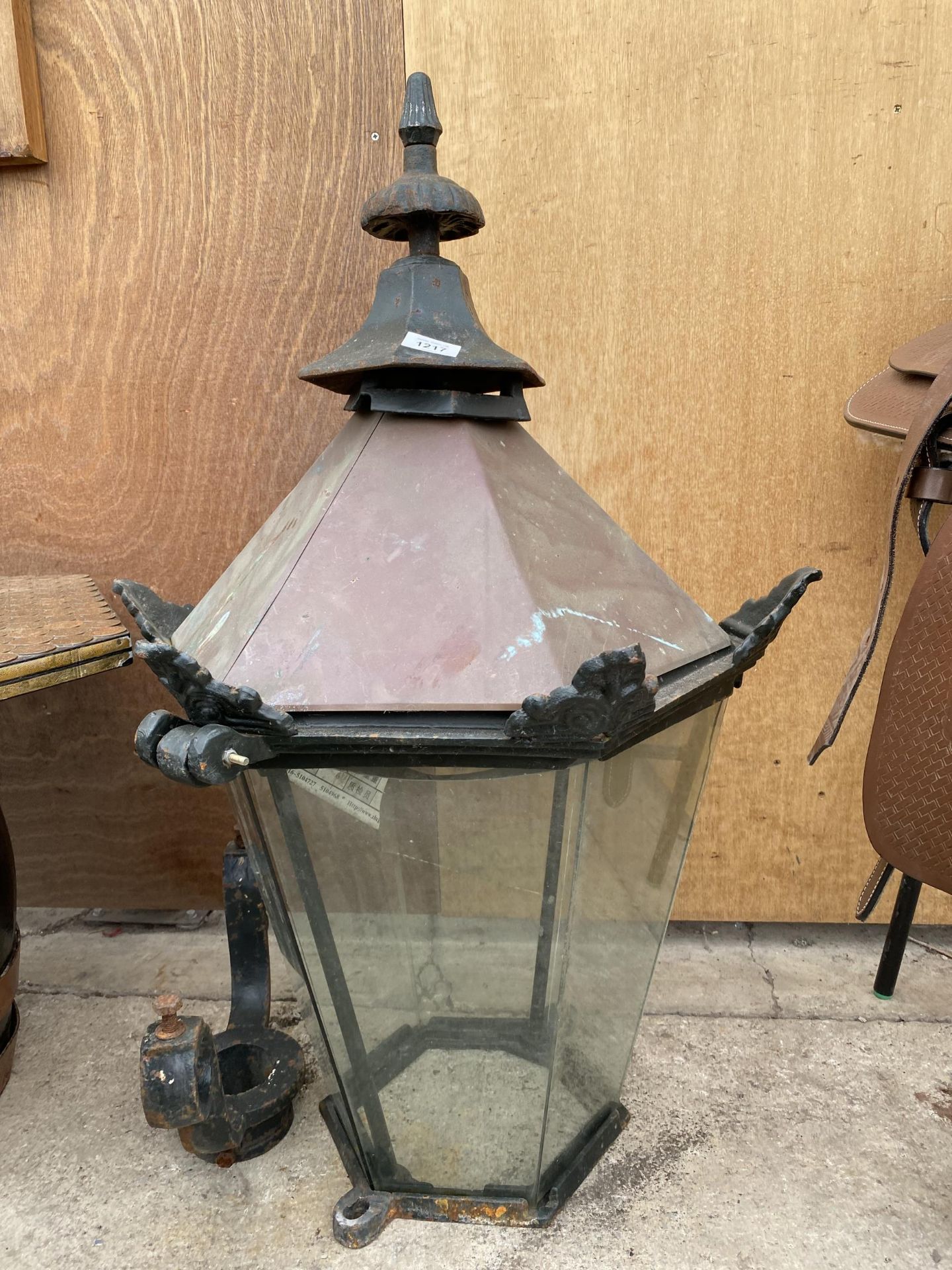 A LARGE VINTAGE CAST IRON OUTSIDE LANTERN WITH BRACKET