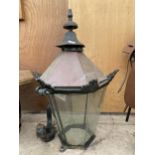 A LARGE VINTAGE CAST IRON OUTSIDE LANTERN WITH BRACKET