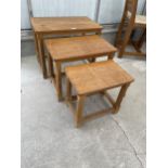 A MID 20TH CENTURY ROBERT 'MOUSEMAN' THOMPSON NEST OF THREE OAK TABLES ON OCTAGONAL LEGS, WITH ADZED