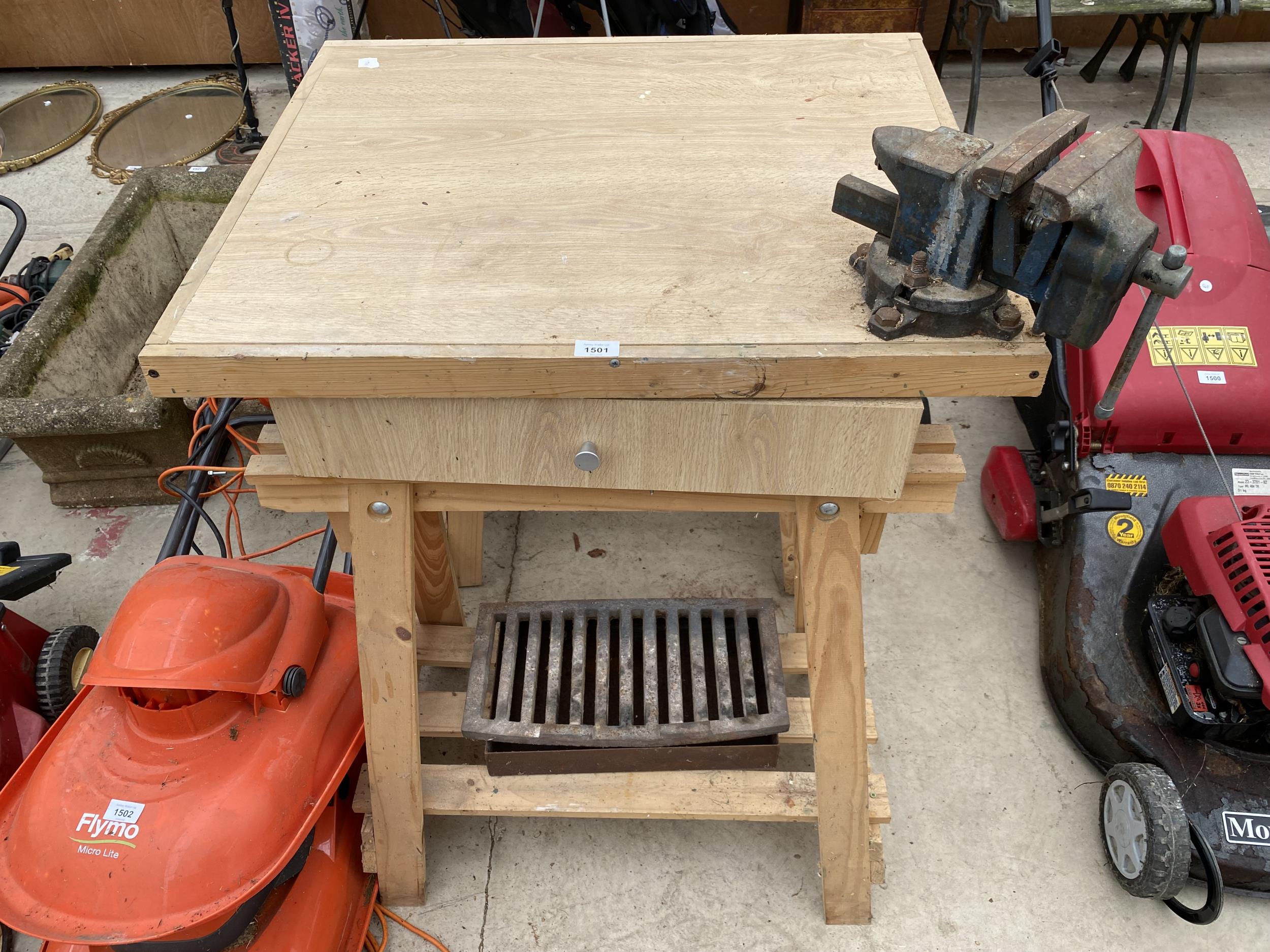 A WOODEN WORK BENCH WITH A BENCH VICE