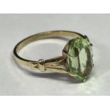 A 9 CARAT GOLD RING WITH A LARGE LIGHT GREEN STONE SIZE N