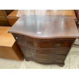 A REPRODUCTION SERPENTINE FRONTED CHEST OF FOUR DRAWERS WITH DRESSING SLIDE, 28" WIDE