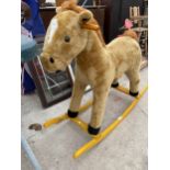 A CHILDS ROCKING HORSE WITH NOISE FEATURES