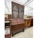 AN EARLY 20TH CENTURY OAK BUREAU BOOKCASE, 36" WIDE