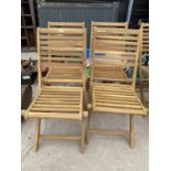 A SET OF FOUR NEW TEAK FOLDING GARDEN CHAIRS