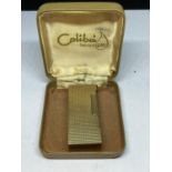 A 9 CARAT GOLD LIGHTER MARKED 375 BELIEVED COLIBRI WITH A PRESENTATION BOX. LIGHTER GROSS WEIGHT
