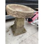 A RECONSTITUTED STONE BIRD BATH WITH PEDESTAL BASE