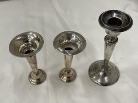 THREE HALMARKED BIRMINGHAM SILVER ITEMS TO INCLUDE A CANDLESTICK AND A PAIR OF BUD VASES
