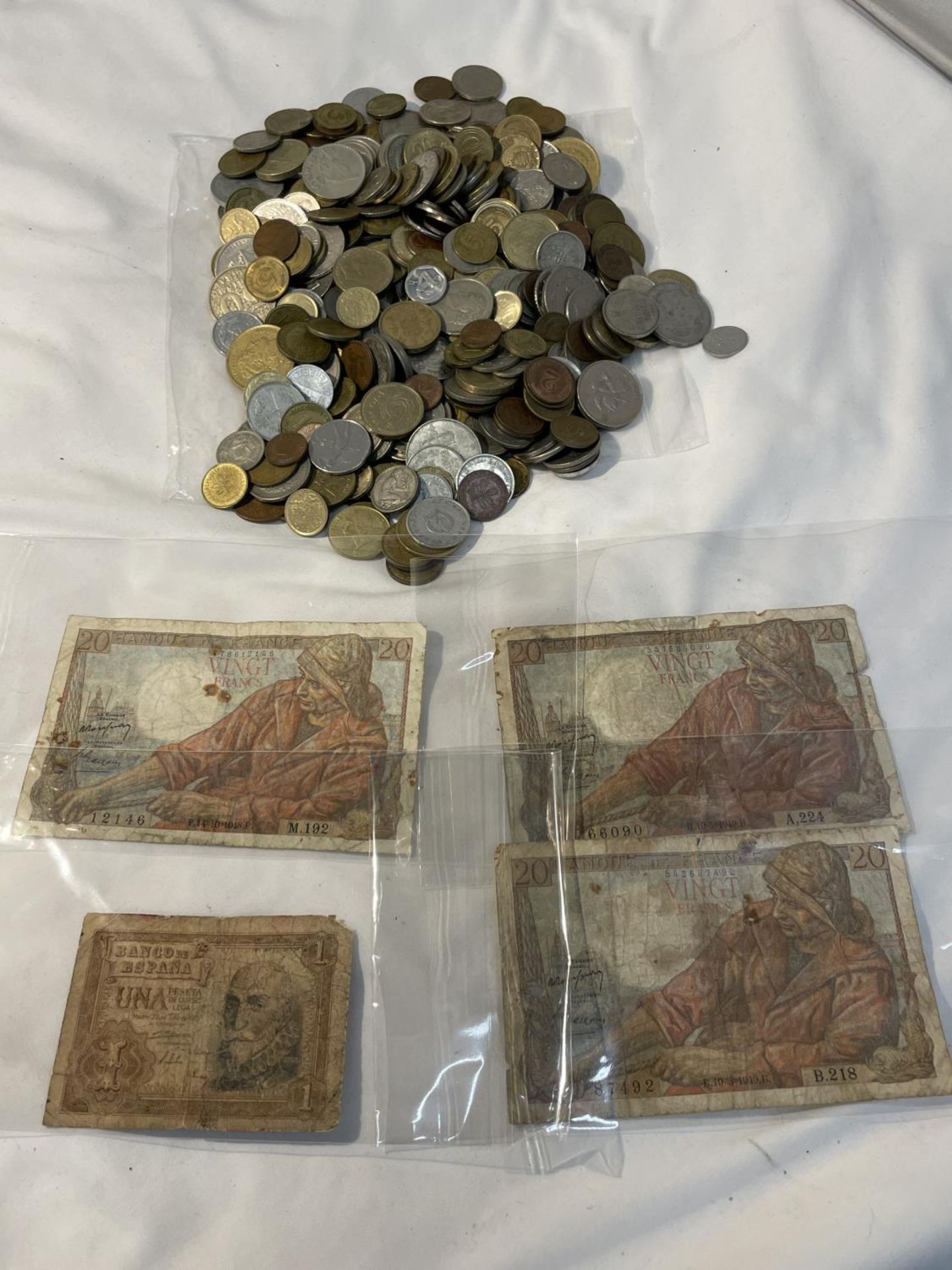 A BAG CONTAINING APPROXIMATELY FOUR HUNDRED MIXED INTERNATIONAL COINS AND SOME BANK NOTES