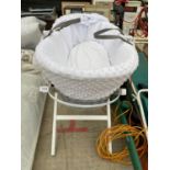 A WICKER BABYS MOSES BASKET WITH STAND