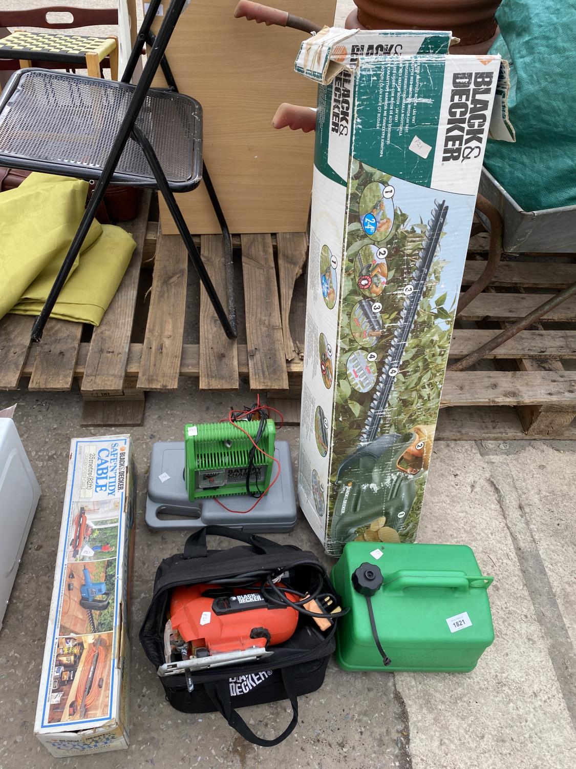 AN ASSORTMENT OF TOOLS TO INCLUDE A BLACK AND DECKER JIGSAW, A BATTERY CHARGER AND A HEDGE TRIMMER