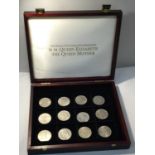 A COLLECTION OF TWELVE COMMEMORATIVE COINS IN A CASE