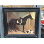 A DARK FRAMED PRINT OF A HORSE AND A DOG IN A STABLE