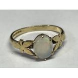 A 9 CARAT GOLD RING WITH A CENTRE OPAL SIZE J