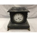 A HEAVY VINTAGE MANTEL CLOCK WITH BRASS DECORATION AND CLAW FEET