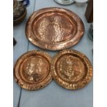 A LARGE AND TWO SMALLER HAND HAMMERED COPPER CHARGERS DIAMETERS 53CM AND 29CM