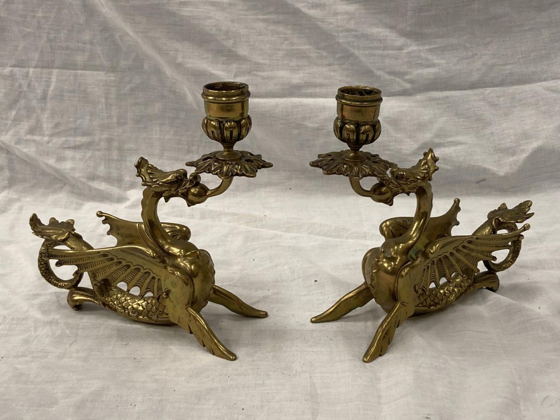 A PAIR OF BRASS 'WELSH DRAGON' CANDLESTICKS HEIGHT 17.5CM, LENGTH 17CM