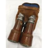 A PAIR OF LEATHER CLAD BINOCULARS IN A LEATHER CASE
