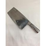 A MEAT CLEAVER WITH A SILVER PLATED HANDLE