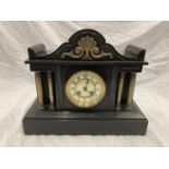 A SLATE VICTORIAN MANTLE CLOCK WITH ENAMELLED FACE, COLUMN DECORATION AND PENDULUM. WIDTH 38CM,