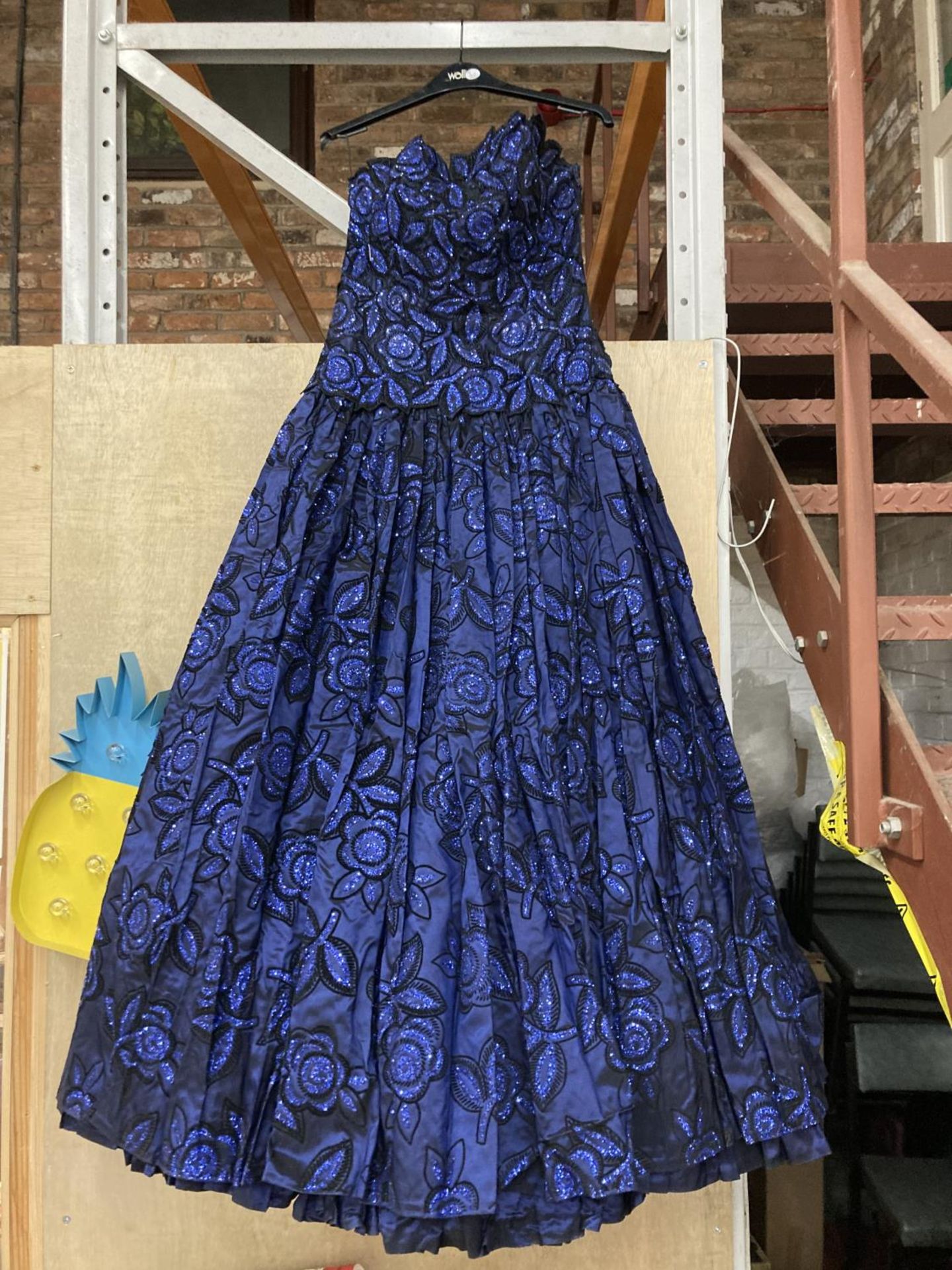 A MIDNIGHT BLUE DESIGNER SEQUINED SPECIAL OCCASION DRESS. SMALL SIZE
