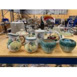 A QUANTITY OF CERAMICS TO INCLUDE A CHEESE DOME, BASKET WITH CERAMIC FRUIT, PLANTERS, BISCUIT