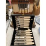 A MAHOGANY BOXED CANTEEN OF CUTLERY AND A BOXED FISH KNIFE AND FORK SET