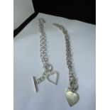 TWO MARKED SILVER T BAR NECKLACES WITH HEART PENDANTS