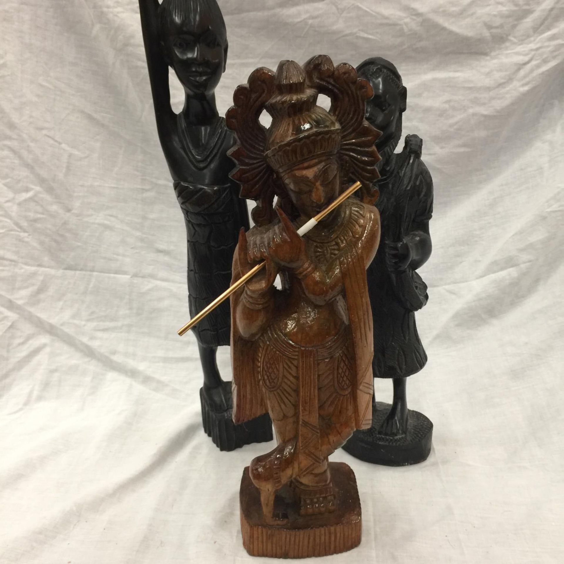 THREE CARVED WOODEN FIGURES - TWO AFRICAN HEIGHT 64CM AND 43CM AND AN ASIAN EXAMPLE HEIGHT 43CM