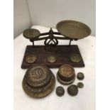 A VINTAGE BRASS AND WOOD POST OFFICE WEIGHING SCALE AND WEIGHTS