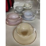 A COLLECTION OF ARCOPAL CUPS AND SAUCERS IN PASTEL SHADES