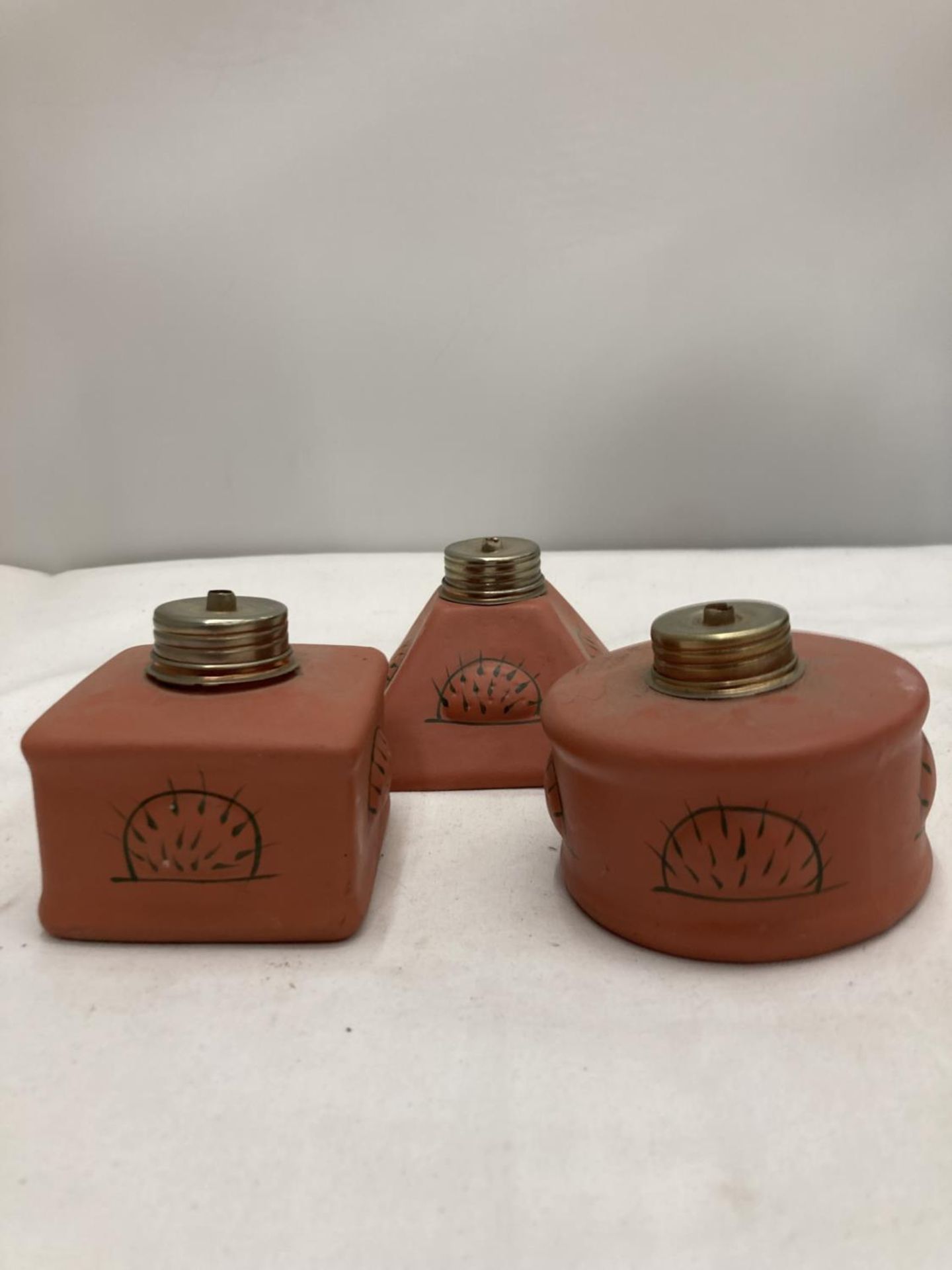 A SET OF THREE TERRACOTTA INCENSE BURNERS